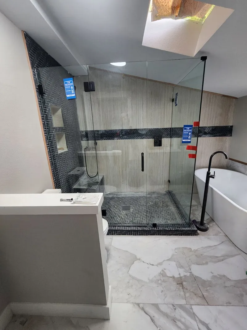 Shower enclosure beside a freestanding tub
